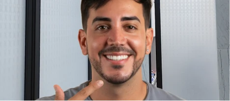 Smiling patient showing natural-looking porcelain veneer results after a smile makeover.
