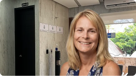 Smiling woman sharing her life-changing testimonial after a full smile makeover restoration using aesthetic dental crowns.