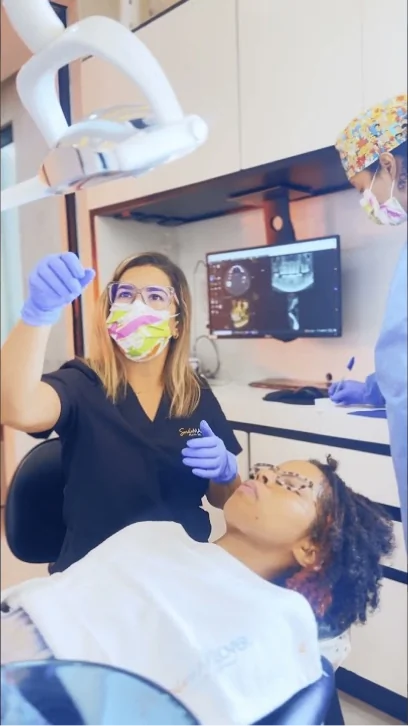 Dentist showing digital 3D scans during a custom dental crowns consultation. Inside look at a modern, world-class dental clinic.