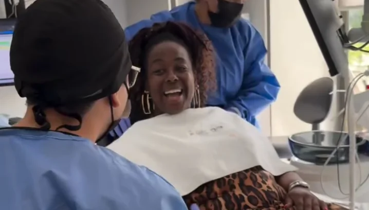 Happy patient receiving care during an All-on-4 dental implant treatment appointment.