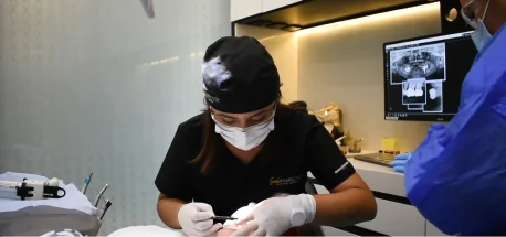 Orthodontist examining teeth before orthodontic treatment using advanced digital technology.