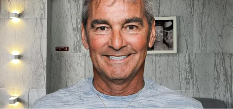 Smiling patient after completing orthodontic treatment and restorative dental care.