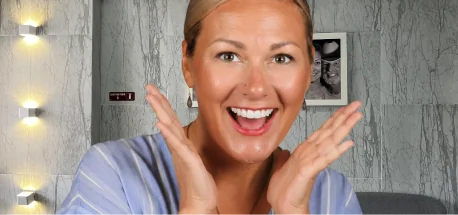 Patient smiling confidently after completing a personalized smile enhancement treatment.