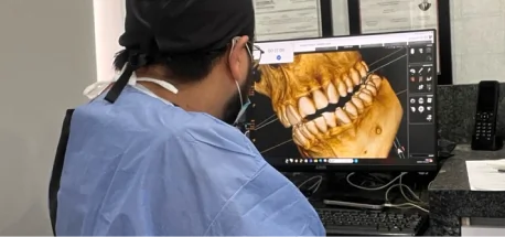Dentist using advanced digital smile design technology to plan tooth restoration after root canal treatment.