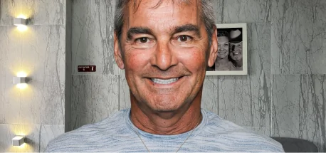 Portrait of a man smiling confidently, demonstrating the aesthetic results of ultra-thin veneer treatment.