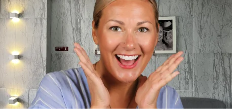 Woman expressing joy and excitement while showcasing her beautiful, restored smile.