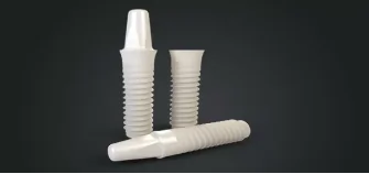 White zirconia dental implants displayed to illustrate metal-free implant treatment options.